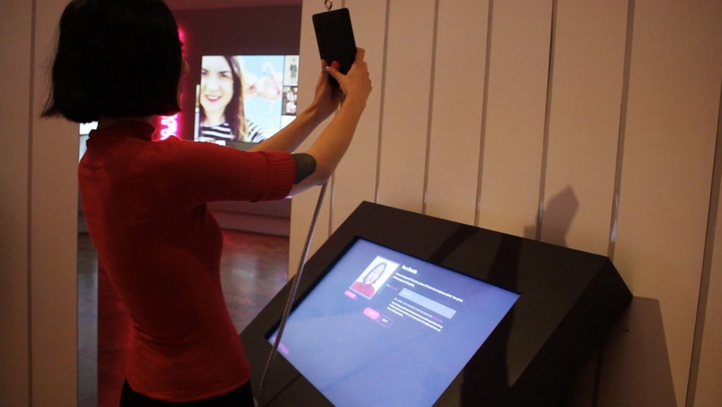 Visitor taking a selfie using the kiosk.